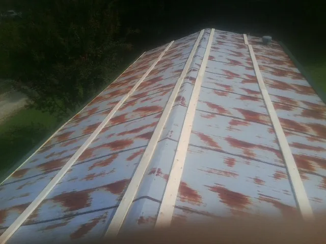 Rusted metal roof panels with new wood purlins before replacement — Storm Damage Roof Repair in Alcester by Roofing Brothers